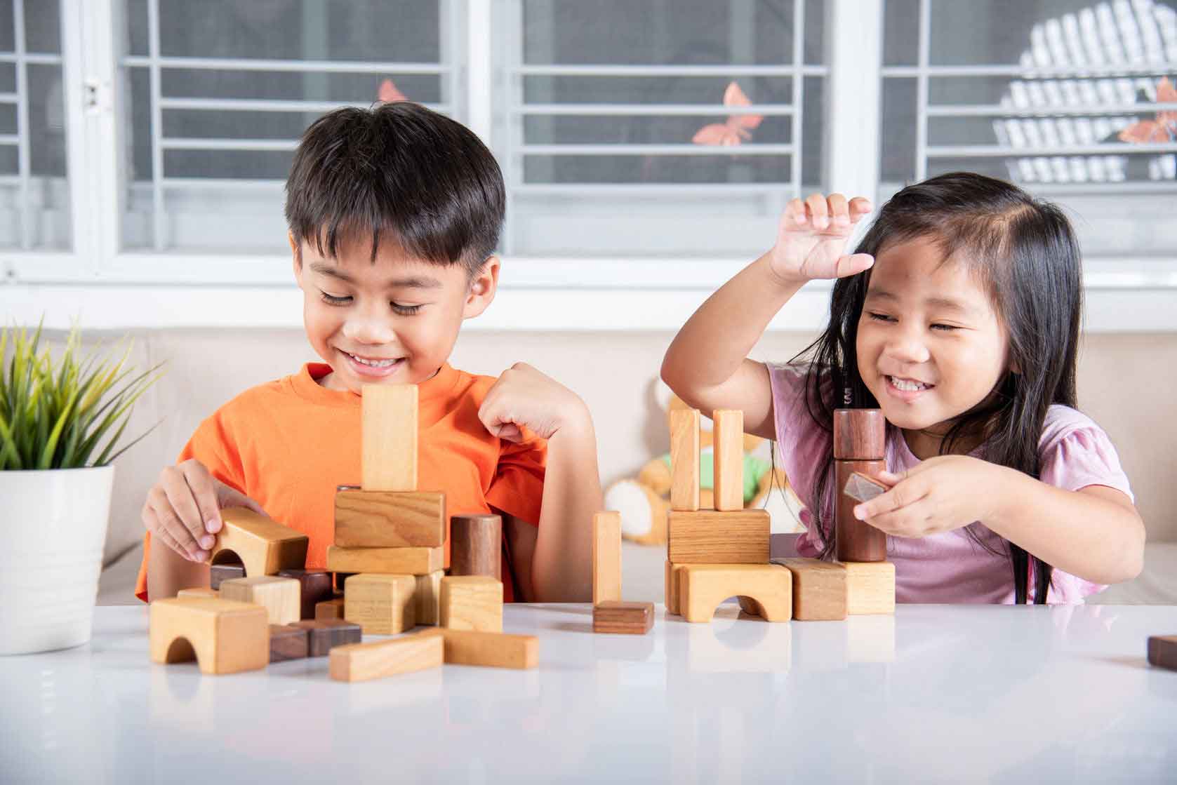 Blocking child. Children playing with Wooden Toys.